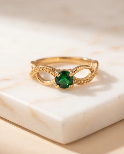 Gold Emerald Round Infinity Twist Ring